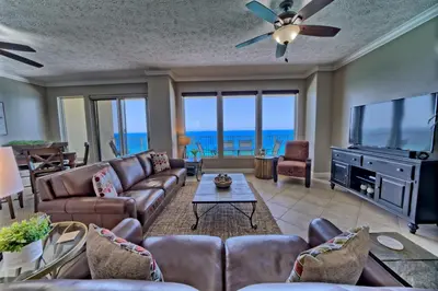 a living room with a couch and a tv at Luxurious High-Rise Condo with Spacious Balcony Facing the Ocean - Unit 1805 in Panama City Beach