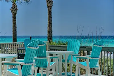a group of chairs and tables on the beach at Luxurious High-Rise Condo with Spacious Balcony Facing the Ocean - Unit 1805 in Panama City Beach