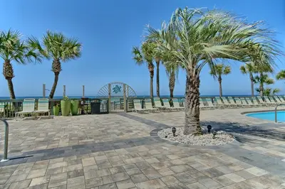 a resort with palm trees and a swimming pool at Luxurious High-Rise Condo with Spacious Balcony Facing the Ocean - Unit 1805 in Panama City Beach