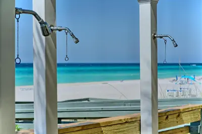 a view of the beach from a beach house window at Luxurious High-Rise Condo with Spacious Balcony Facing the Ocean - Unit 1805 in Panama City Beach