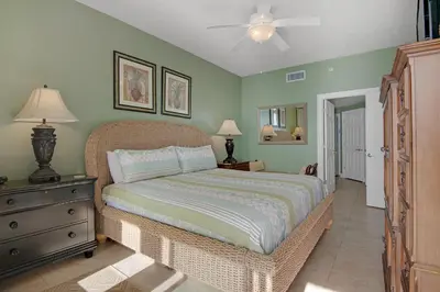 a bedroom with a bed and a ceiling fan at Tropical High-Rise Condo with Beachside Pool Access and Free Poolside WiFi - Unit 2004 in Panama City Beach