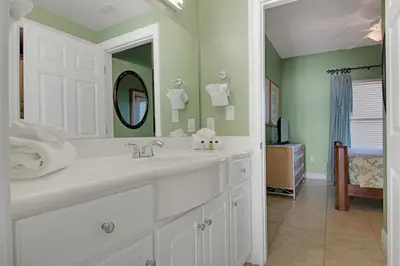 a bathroom with a sink and a mirror at Tropical High-Rise Condo with Beachside Pool Access and Free Poolside WiFi - Unit 2004 in Panama City Beach