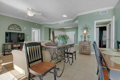 a kitchen and dining room with a table and chairs at Tropical High-Rise Condo with Beachside Pool Access and Free Poolside WiFi - Unit 2004 in Panama City Beach
