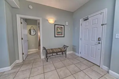 a hallway with a bench in front of a door at Luxurious Beachfront Condo with Beachside Pool Access and Free WiFi - Unit 1202 in Panama City Beach