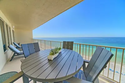 a table and chairs on a balcony with the ocean at Luxurious Beachfront Condo with Beachside Pool Access and Free WiFi - Unit 1202 in Panama City Beach