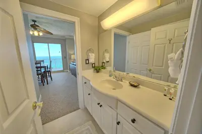a bathroom with a sink and a large mirror at Stylish Oceanfront Condo with Beach and Picnic Area Access - Unit 1706 in Panama City Beach