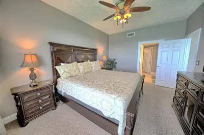 a bedroom with a bed and a ceiling fan at Stylish Oceanfront Condo with Beach and Picnic Area Access - Unit 1706 in Panama City Beach