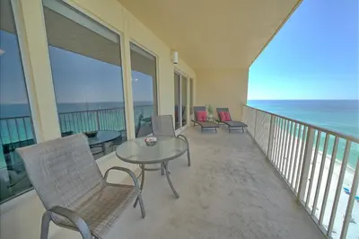 a balcony with chairs and a table and the ocean at Stylish Oceanfront Condo with Beach and Picnic Area Access - Unit 1706 in Panama City Beach