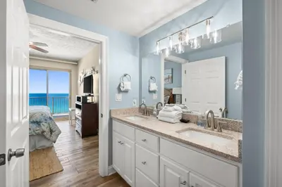 a bathroom with two sinks and a large mirror at Beautiful Condo with Spacious Balcony to Enjoy Fascinating Ocean View - Unit 1002 in Panama City Beach