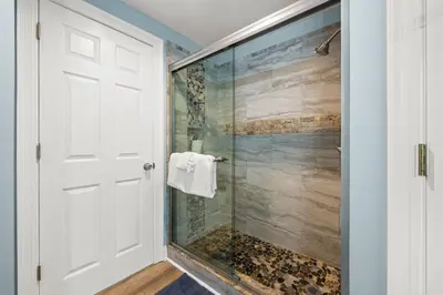 a bathroom with a shower with a glass door at Beautiful Condo with Spacious Balcony to Enjoy Fascinating Ocean View - Unit 1002 in Panama City Beach