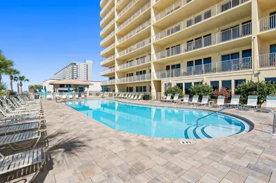 a swimming pool in front of a hotel at Beautiful Condo with Spacious Balcony to Enjoy Fascinating Ocean View - Unit 1002 in Panama City Beach