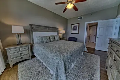 a bedroom with a bed and a ceiling fan at Pleasant Oceanfront Condo with Large Balcony and Beach Access - Unit 1605 in Panama City Beach