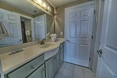 a bathroom with a sink and a mirror at Pleasant Oceanfront Condo with Large Balcony and Beach Access - Unit 1605 in Panama City Beach