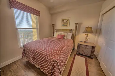 a bedroom with a bed and a window at Stunning 16th Floor Condo with Fitness Center, Hot Tubs, Pools, and Beach Access - Unit 1606 in Panama City Beach
