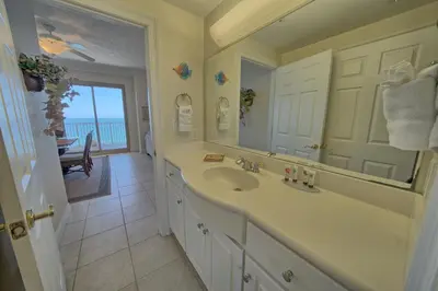 a bathroom with a sink and a large mirror at Stunning 16th Floor Condo with Fitness Center, Hot Tubs, Pools, and Beach Access - Unit 1606 in Panama City Beach