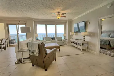 a living room with a bedroom and a living room with a bed at Gulf Front Condo with Beach Access and Beachside Pool - Unit 1604 in Panama City Beach