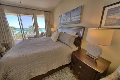 a bedroom with a bed and a table with a lamp at Astonishing Oceanfront Condo with Oversized Balcony to Enjoy Amazing Gulf View - Unit 0204 in Panama City Beach