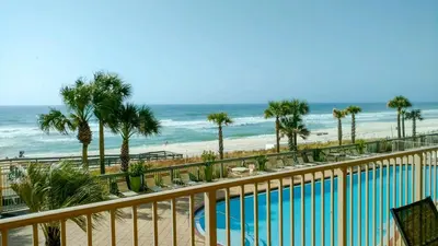 a view of a beach with a pool and palm trees at Astonishing Oceanfront Condo with Oversized Balcony to Enjoy Amazing Gulf View - Unit 0204 in Panama City Beach