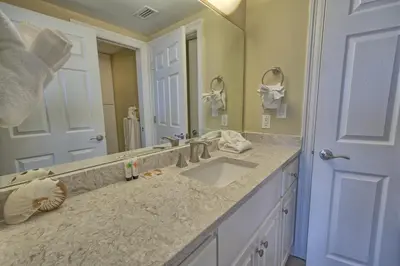 a bathroom with a sink and a large mirror at Astonishing Oceanfront Condo with Oversized Balcony to Enjoy Amazing Gulf View - Unit 0204 in Panama City Beach