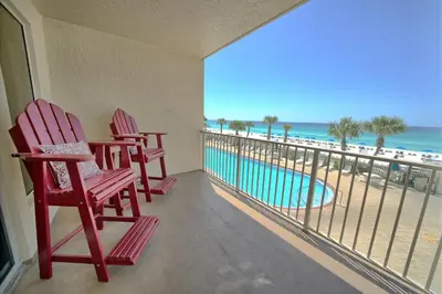 a balcony with two chairs and a view of the ocean at Astonishing Oceanfront Condo with Oversized Balcony to Enjoy Amazing Gulf View - Unit 0204 in Panama City Beach