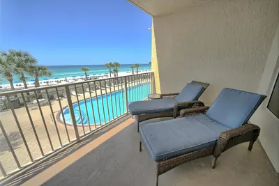 a balcony with chairs and a view of the beach at Astonishing Oceanfront Condo with Oversized Balcony to Enjoy Amazing Gulf View - Unit 0204 in Panama City Beach