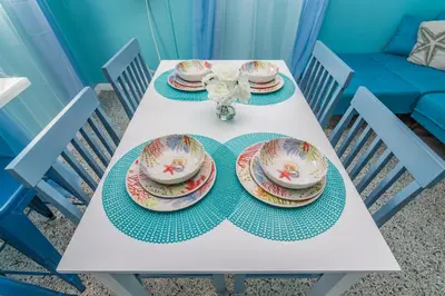 a white table with plates and dishes on it at Villa Paradise, Pet Friendly in Panama City Beach