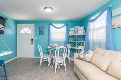 a living room with a couch and a table at Villa Serenity, Pet Friendly in Panama City Beach
