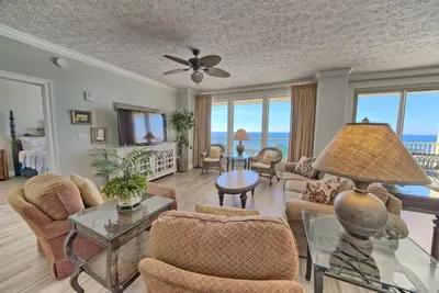 a living room with a view of the ocean at Tropical Gulf Front Condo with Picnic Area & Grills - Unit 0802 in Panama City Beach