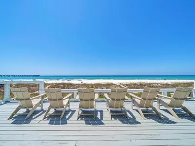 a group of chairs and a table on the beach at Fishers in Panama City Beach