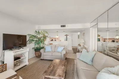 a living room with a couch and a table at Pinnacle Port C1-203 in Carillon Beach