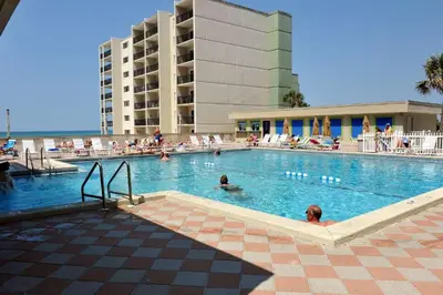 a swimming pool with people in a hotel at Pinnacle Port C1-203 in Carillon Beach