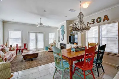 a dining room and living room with a table and chairs at Seabreeze Cottage #45 in Watersound Beach