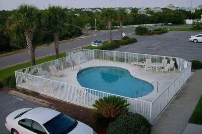 a swimming pool with a white fence around it at Seabreeze Cottage #45 in Watersound Beach