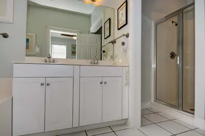 a white bathroom with two sinks and a shower at 2 Blessed 2 Be Stressed in Watersound Beach