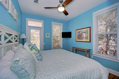 a blue bedroom with a bed and two windows at 2 Blessed 2 Be Stressed in Watersound Beach