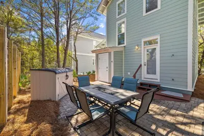 a patio with a table and chairs in front of a house at 2 Blessed 2 Be Stressed in Watersound Beach