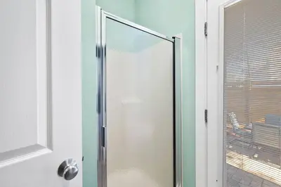 a glass shower door in a bathroom with a window at 2 Blessed 2 Be Stressed in Watersound Beach
