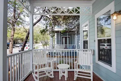 a white porch with two chairs and a table at 2 Blessed 2 Be Stressed in Watersound Beach