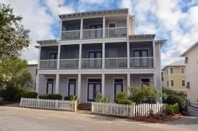 a large white house with a white fence at Grace Villa in Watersound Beach