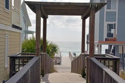 a wooden boardwalk leading down to the beach at Grace Villa in Watersound Beach