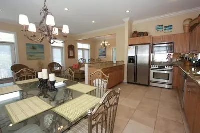 a kitchen with a table and a dining room at Grace Villa in Watersound Beach