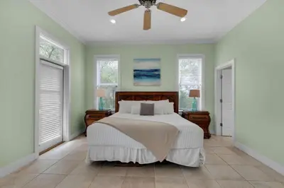 a bedroom with a bed and a ceiling fan at Grace Villa in Watersound Beach
