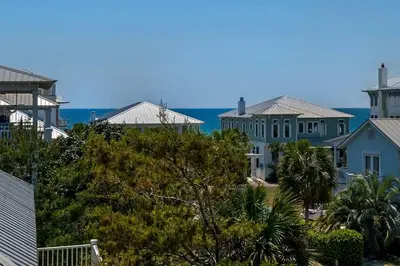 a group of houses with the ocean in the background at Beach Breeze in Watersound Beach