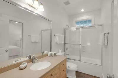 a bathroom with a sink and a shower and a toilet at Beach Breeze in Watersound Beach