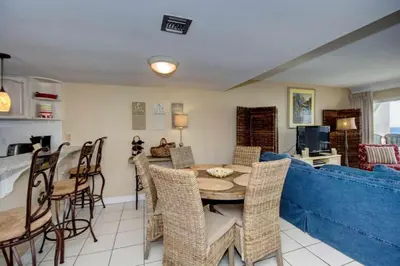 a living room with a table and a blue couch at Pinnacle Port C1-302 in Carillon Beach