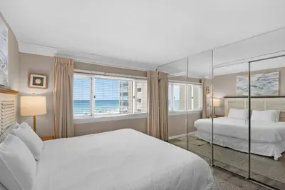 a bedroom with two beds and a large window at Pinnacle Port C1-302 in Carillon Beach