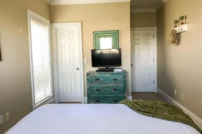 a bedroom with a bed and a television on a dresser at Key Largo in Seagrove Beach