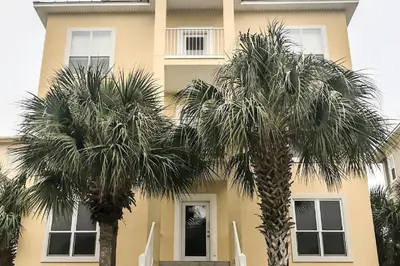 two palm trees in front of a building at Key Largo in Seagrove Beach