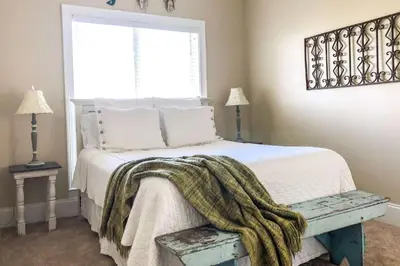 a bedroom with a bed with a blanket on it at Key Largo in Seagrove Beach
