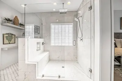 a white bathroom with a shower and a sink at Key Largo in Seagrove Beach